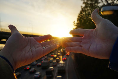 Close-up of man holding sun in car