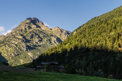 Scenic view of mountains against clear blue sky