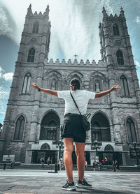 Full length of man standing outside temple against building