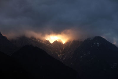 Scenic view of mountains against sky at night