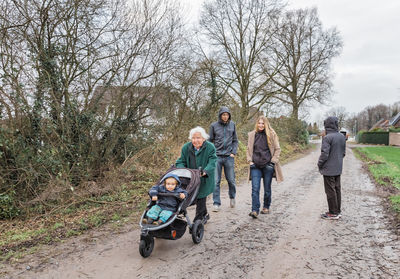 People walking on road against sky