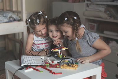 High angle view of girl playing with christmas decoration