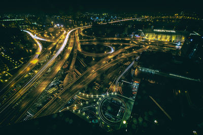 High angle view of illuminated cityscape at night during monsoon