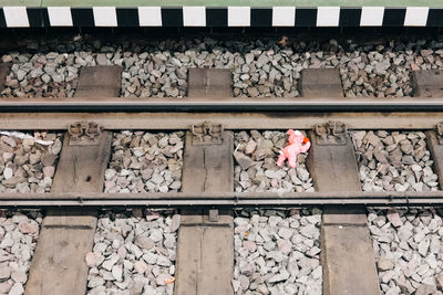 High angle view of abandoned stuffed toy on railroad tracks