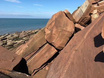 Panoramic view of rocks on beach against sky