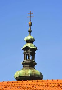 Low angle view of bell tower against blue sky