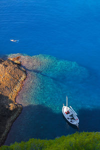 High angle view of sailboats moored on sea