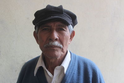 Portrait of man standing against wall