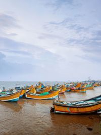 Boats moored on sea against sky