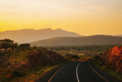 An empty highway against a golden sunset at iringa, tanzania 