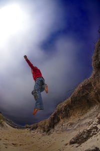 Full length of man jumping in mountains