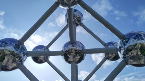 Low angle view of metallic structure on street against sky