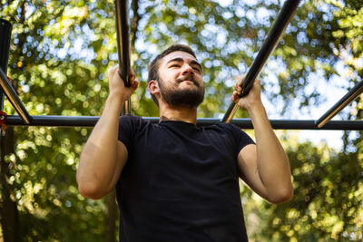 Sport man stretching at the park autumn, doing man do stretching exercises at autumn park. 