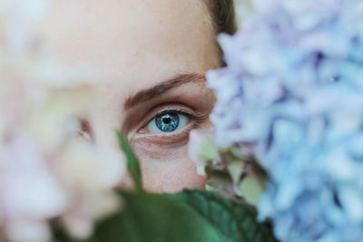 Close-up portrait of woman with red eyes closed