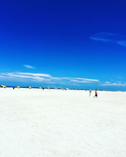 Scenic view of beach against clear blue sky