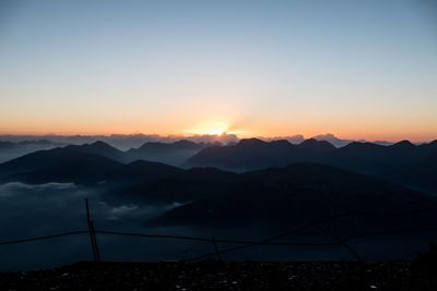 Scenic view of silhouette mountains against sky during sunset