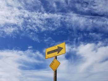 Low angle view of road sign against sky