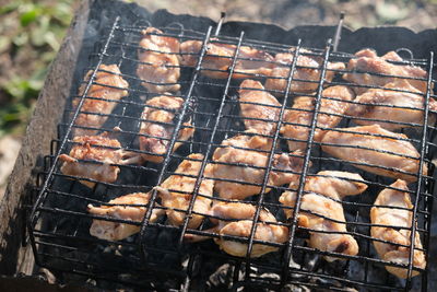 High angle view of meat on barbecue grill