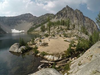 Scenic view of lake and mountains against sky