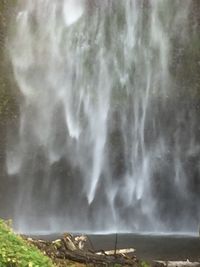 Scenic view of waterfall against sky