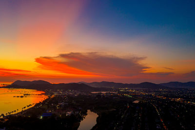 High angle view of illuminated cityscape against sky during sunset