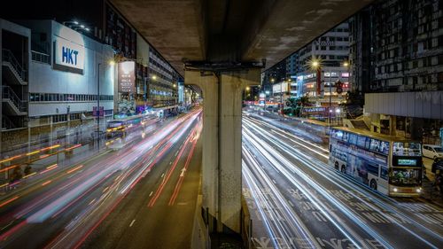 Light trails on road along buildings at night