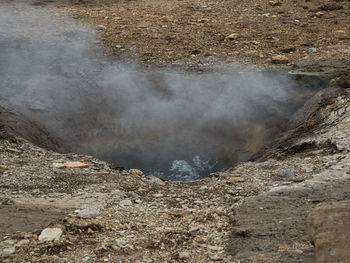 High angle view of smoke emitting from land