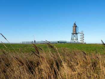 Scenic view of agricultural field against clear blue sky