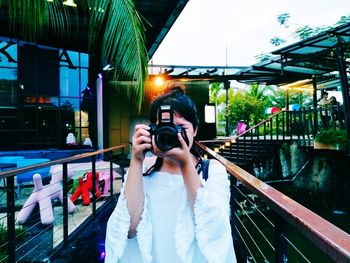 Woman photographing at camera