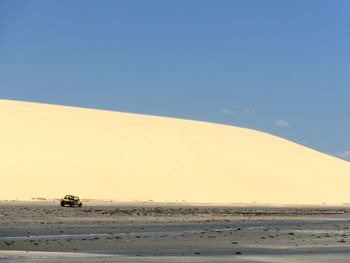 Scenic view of desert against clear blue sky