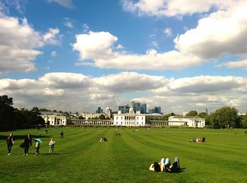 People in park in city against sky