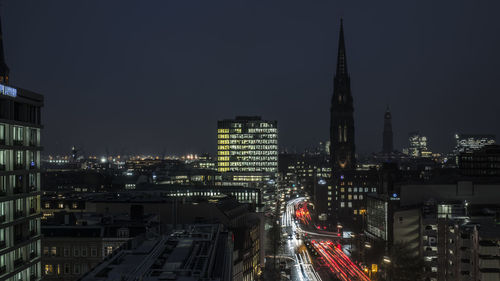 High angle view of illuminated buildings against sky at night