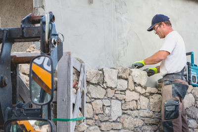 Side view of man working at construction site