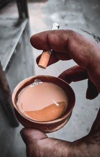 Close-up of hand holding coffee