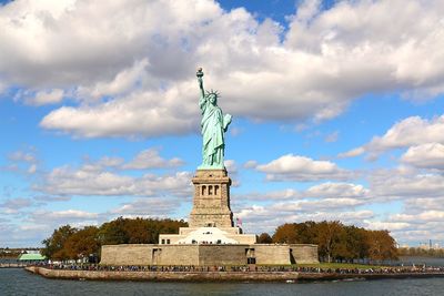 Statue of liberty against cloudy sky
