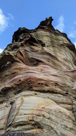 Low angle view of rock formation against sky