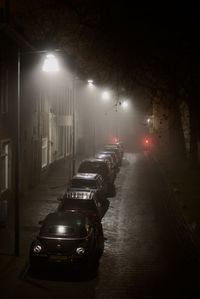Cars moving on illuminated street at night