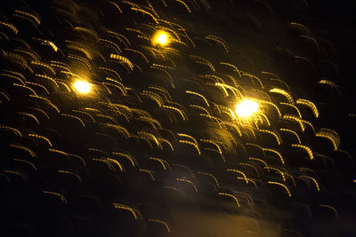 Low angle view of illuminated sky at night