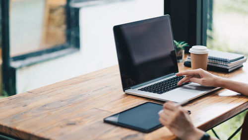 Cropped hands of businesswoman working at office