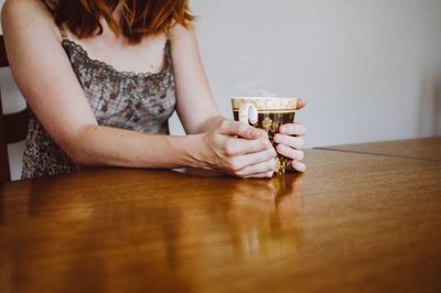 Young woman standing on tiled floor