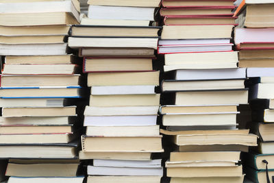 Full frame shot of stacked books in library