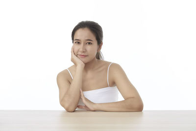 Portrait of a smiling young woman over white background