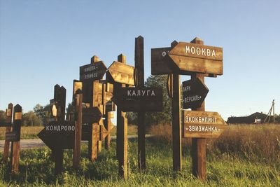 Information sign on field against clear sky