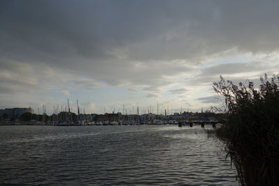 Scenic view of sea by buildings against sky