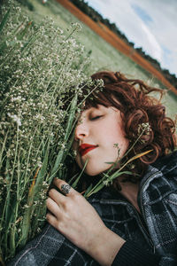 Portrait of beautiful young woman holding plant