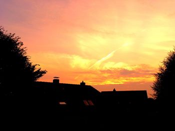 Silhouette of trees against sky at sunset