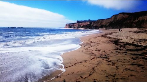 View of beach against cloudy sky