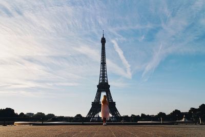 Rear view full length of woman standing against eiffel tower