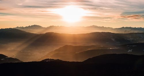 Scenic view of silhouette mountains against sky at sunset