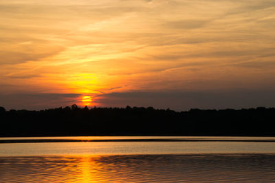 Scenic view of lake against romantic sky at sunset